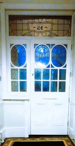 white front door with stain glass