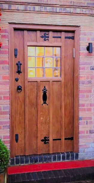a wooden front door with glass