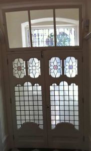 two wooden front doors with stain glass patterns