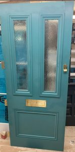 Blue wooden front door in workshop uninstalled