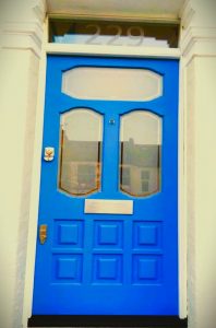 Blue wooden door front of house