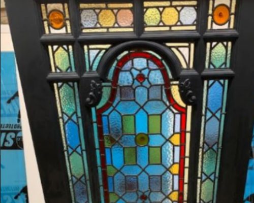 Black Door with stained leaded glass inserts.